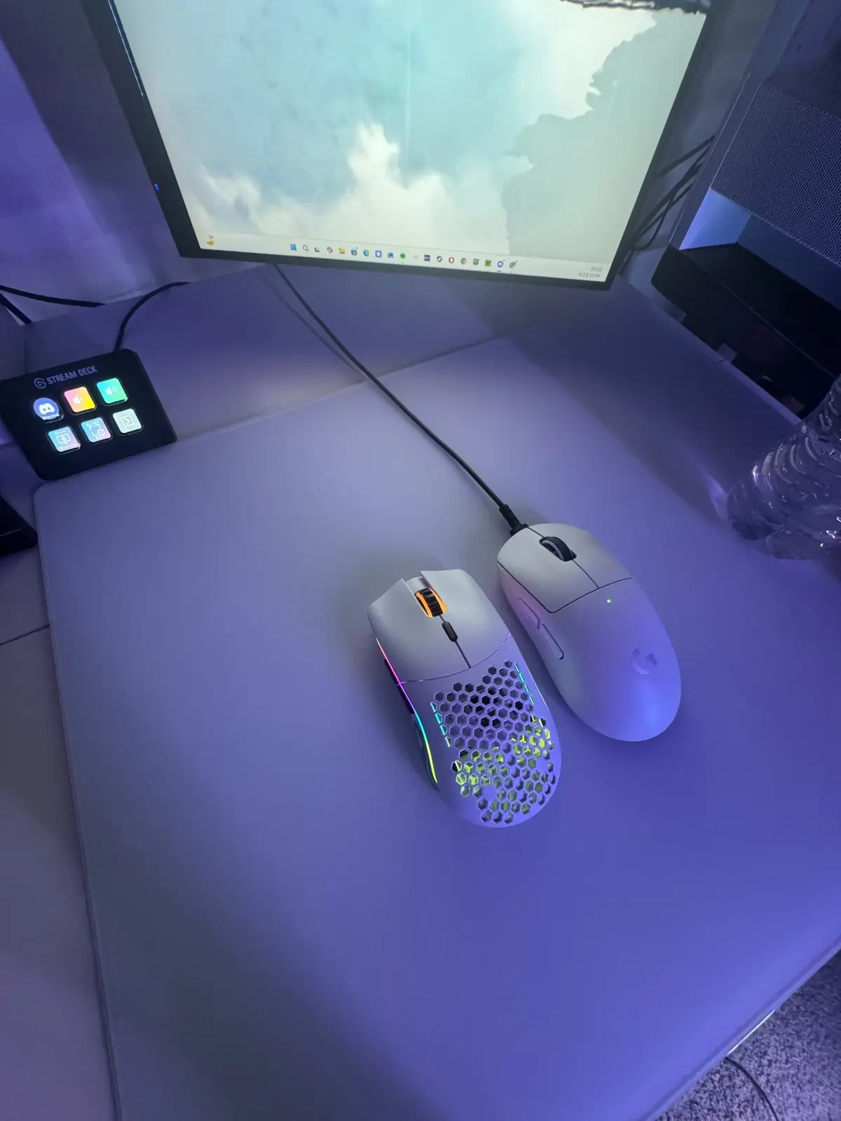 White Glorious Model O Wireless and Logitech G Pro X Superlight 2 Wireless gaming mice beside Travis's monitor