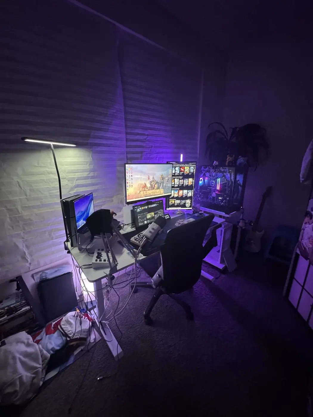 Travis's purple-lit gaming setup with multiple displays and a Jujutsu Kaisen-themed PC